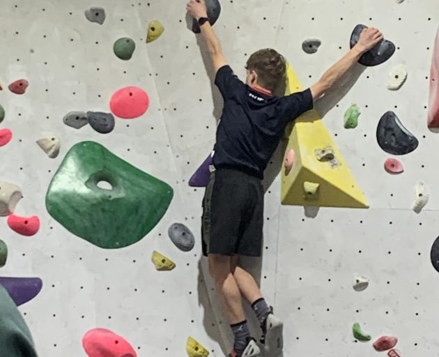 Flynn Richards (Otago Boys’ High School) tries to navigate his way up the climbing wall.