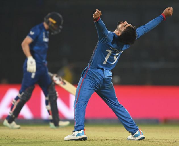 Afghanistan spinner Rashid Khan celebrates capturing the wicket of England’s Mark Wood.  