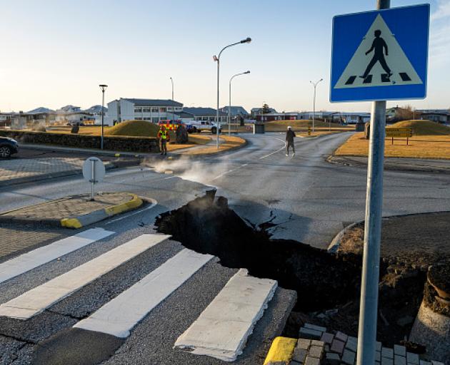 This photo taken on November 13 shows a crack cutting across the main road in Grindavik,...