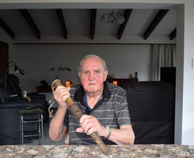 Retired freezing worker Bert Meikle holds a cattle pithing spear he used in the Mataura meatworks...