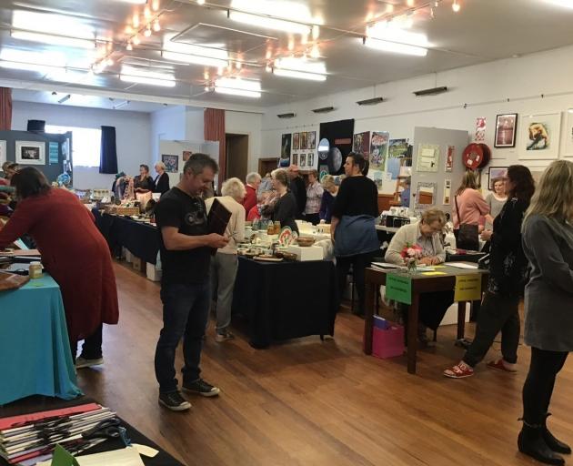 Visitors browse the artworks at a previous OpenArts Annual Art Fair. Photo: supplied