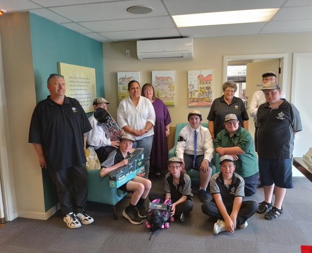 Presenting their donations to the Christmas Angels Project are (back from left) Andre Stokes 15,...