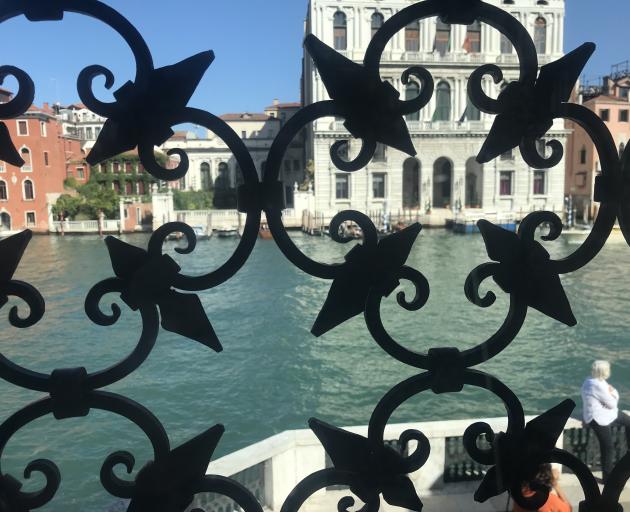Looking at the Grand Canal through a decorative grill in the Palazzo Venier dei Leoni, which...