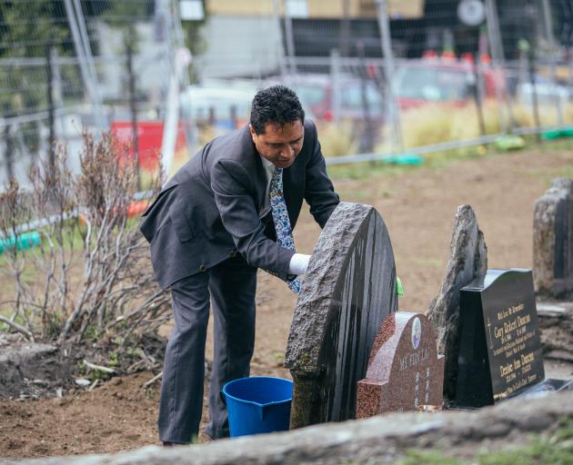 Affinity Funerals funeral manager Paul Tamati works on a stone at the Queenstown Cemetery...