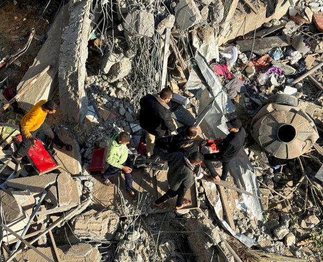 Palestinians search the rubble after an Israeli air strike in the southern Gaza city of Rafa....