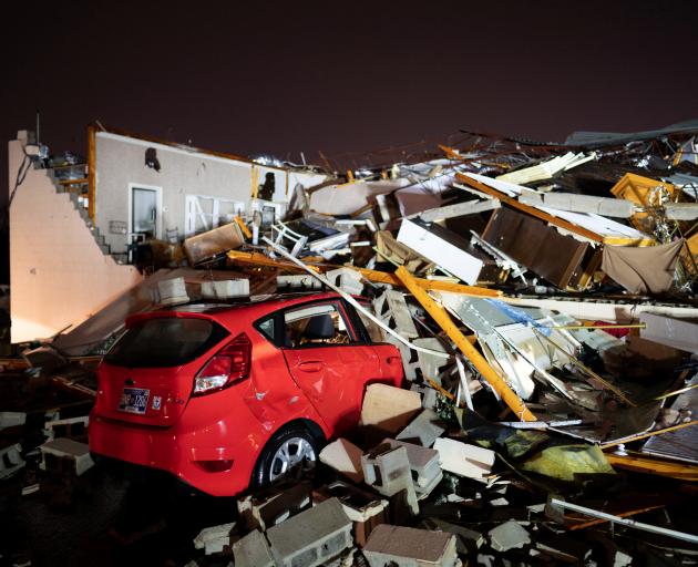 A car is buried under rubble on Main Street after a tornado hit Hendersonville, Tennessee, US on...