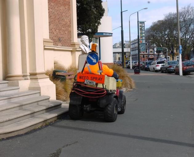 A contractor sprays weeds outside Toitū Otago Settlers Museum. PHOTO: ODT FILES