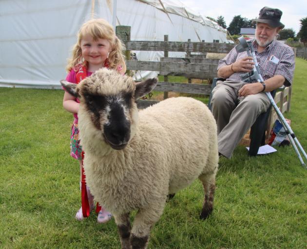 Mandy Corby, 3, of Waikana, is pleased with the first prize she and her lamb Lucy won in the 8...