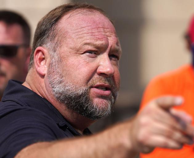 InfoWars founder Alex Jones speaks to the media outside Waterbury Superior Court during his trial...