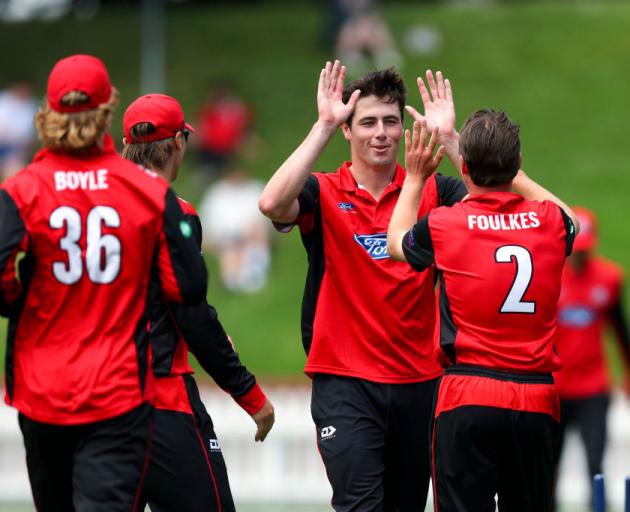 Will O’Rourke (second right) celebrates with his Canterbury team-mates after taking a wicket in...