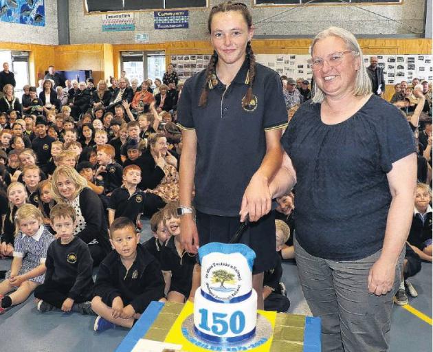 Kaiapoi Borough School pupil Makayla Krahagen, 13, cuts the 150th celebration cake with Board of...