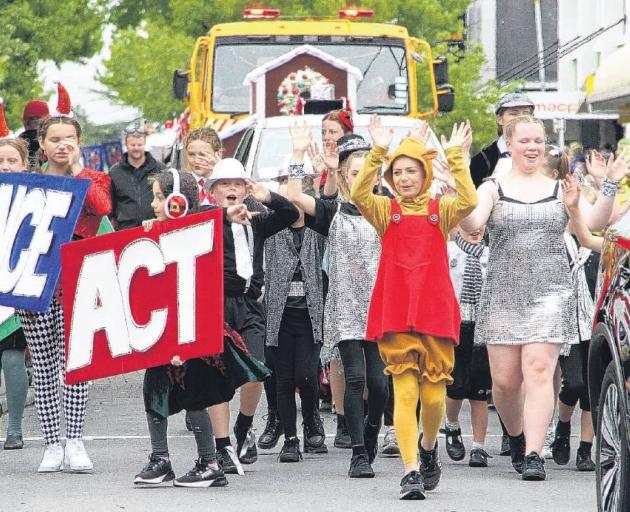 Members of the Hartley School of Performing Arts in Rangiora sing and dance as they walk along...