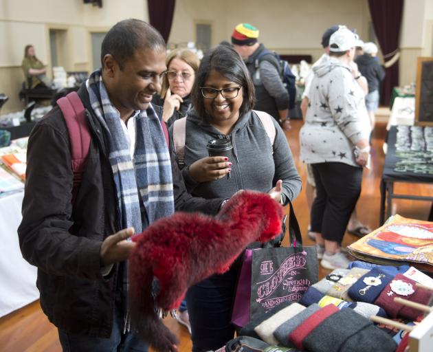 Darian and Caitlin Naidoo take a look at some of the possum fur on sale at the Port Chalmers...