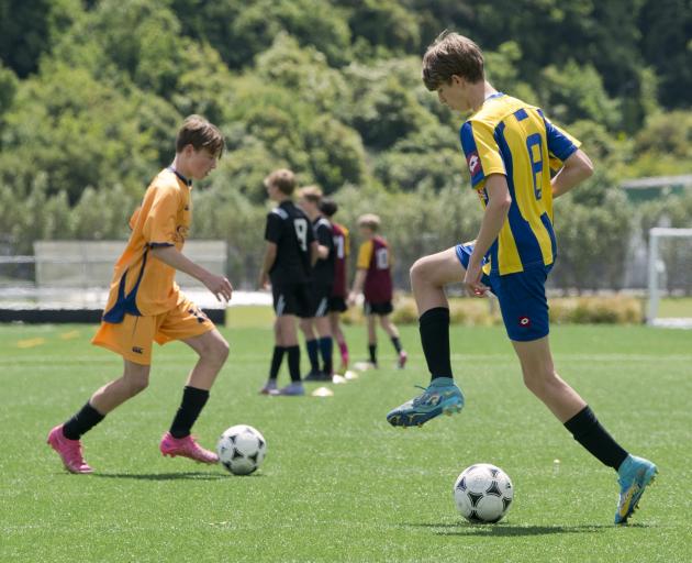 Footballers warm up for the final trial for the Otago youth team heading to the Super Cup in...
