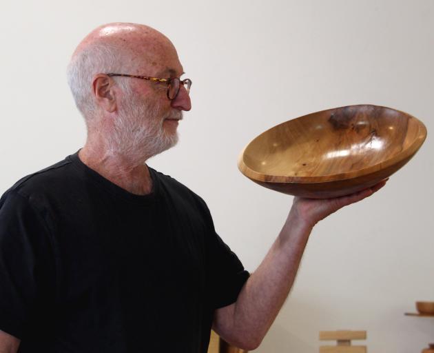Otago Woodturners Guild president Jonathan Leichter admires one of the many pieces on sale at the...