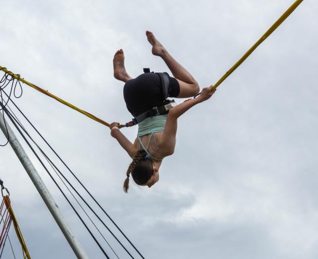 Lily Hamilton, 12, does a flip on the bungy trampoline.