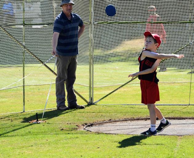 Nikau Anstee, 6, launches a discus as part of Geraldine Athletics Rose Shield competition day.