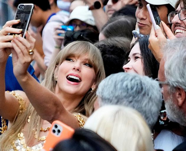 Singer Taylor Swift poses for a selfie with fans as she arrives to speak at the Toronto...