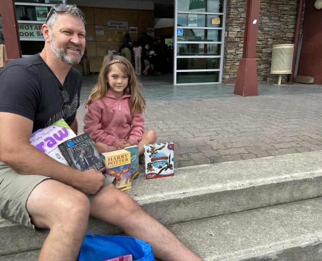 Mike Wilson and daughter Sofia, 7, of Auckland, checking out their selections from the annual...
