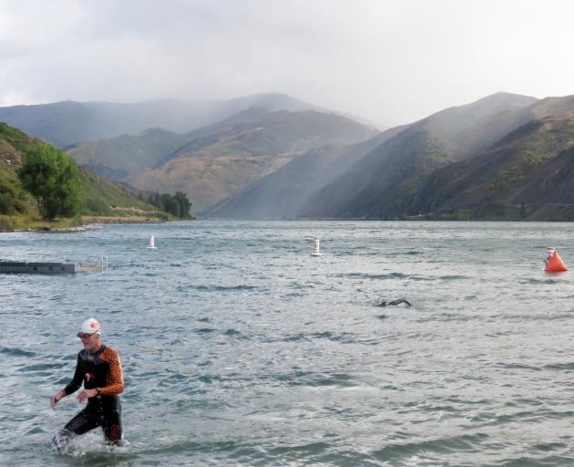 Peter Jackson, of Wānaka, emerges from Lake Dunstan after his 3km swim on Sunday. PHOTO: RUBY SHAW