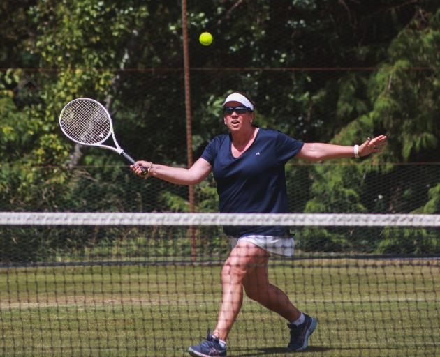 Belinda Hirst rushes to volley a return.
