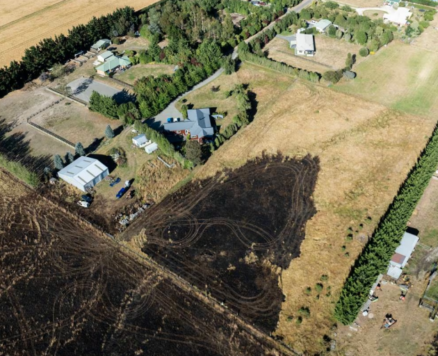 Dramatic images capture the scorched earth mere metres away from homes and buildings. Photo:...