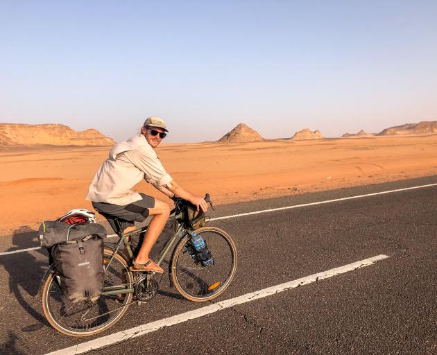 James Beatty riding through the desert in Sudan where temperatures would reach about 50 deg C....