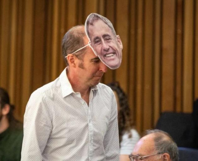 A member of the public wears a Phil Mauger mask at a meeting of the Christchurch City Council....