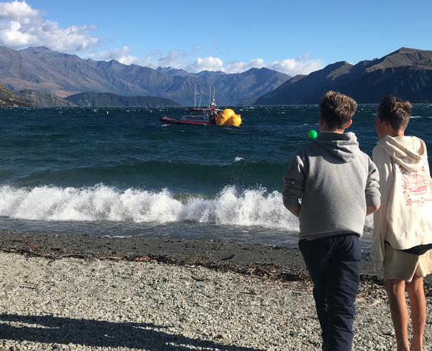 Wanaka Lakes Coastguard bring the large yellow duck buoy to shore. PHOTO: MARJORIE COOK