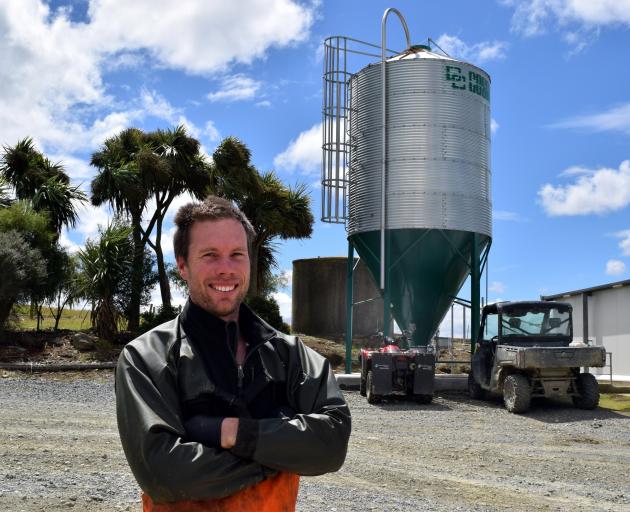 Contract milker Gareth Bearman and a new silo at his family’s milking shed in Crichton.