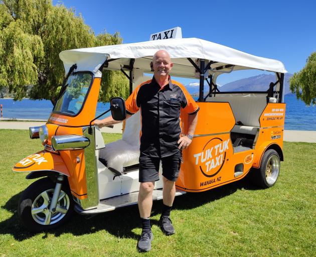 Standing beside one of his new tuk-tuks on the Wanaka lakefront is Tuk Tuk Taxi owner John...