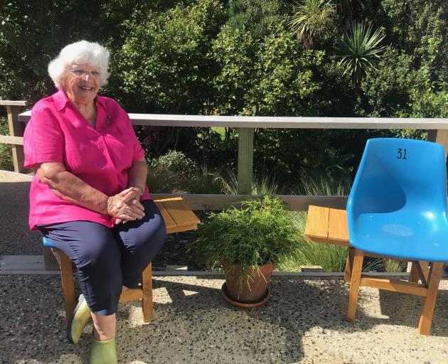 Gill Shelah takes a break on a former Carisbrook seat which has had a side tray added by members...