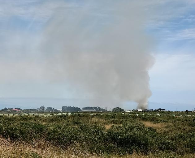 Smoke rises from a grass fire at Oreti Beach. Photo: Toni McDonald 