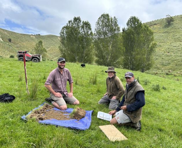 Quorum Sense project leader Sam Lang (left) assesses the soil in a trial paddock with Michael...