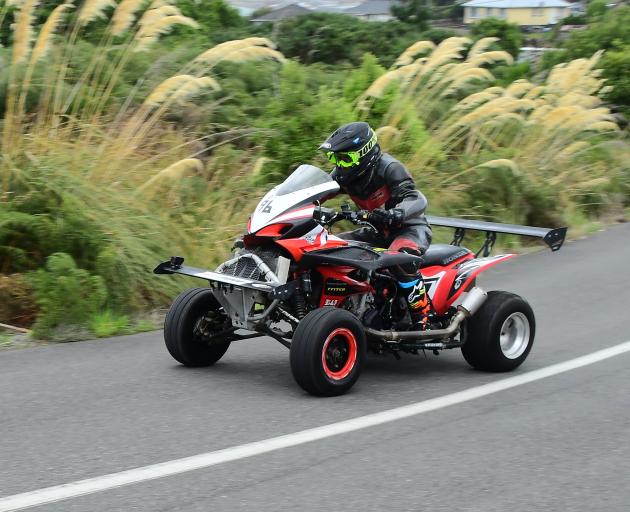 Ian Newman, of Gisborne, powers up the hill on his 1000cc Honda/Suzuki quadbike at the Bluff Hill...