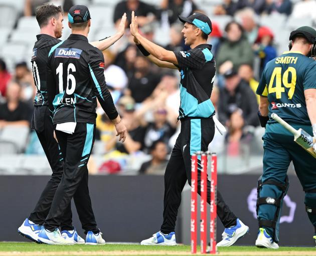 Adam Milne celebrates with Trent Boult after taking the wicket of Australia's Steven Smith. Photo...