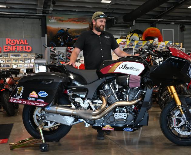 Wanaka Powersports general manager Daniel Irwin admires a $175,000 2023 Indian Challenger RR....