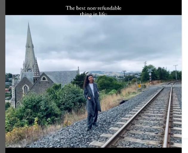 A screenshot from travel blogger Sukanya Chatawitt’s Instagram reel shows her on the train tracks...