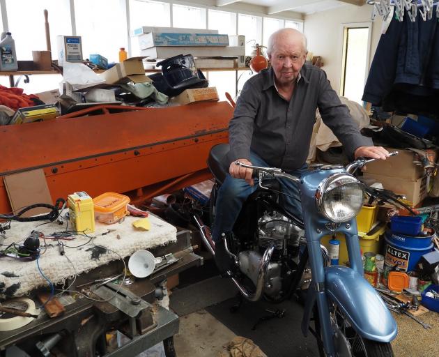 Mervyn Pedersen in his Karitane garage on the latest bike he’s been building from parts, a 1958...