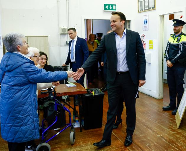 Ireland's Taoiseach (Prime Minister) Leo Varadkar greets people as he arrives to vote in a...
