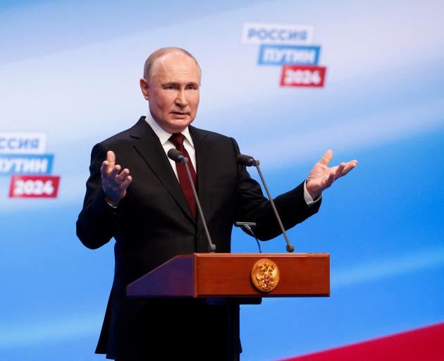 Vladimir Putin speaks at his election campaign headquarters after polling stations closed on the...