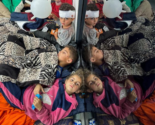 Palestinian children injured by an Israeli airstrike await treatment in Rafah, southern Gaza....