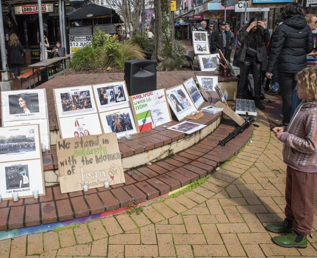 A girl reading protest material at a New Zealand gathering expressing solidarity with the women...