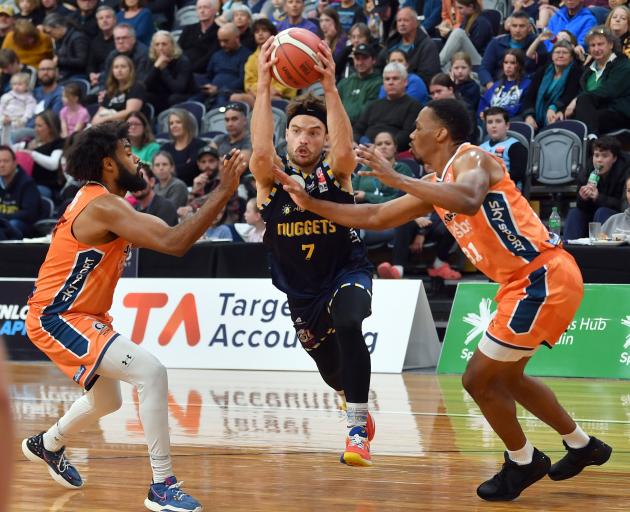 Otago Nuggets guard Matt Bardsley tries to find a way past Southland Sharks defenders Alonzo...