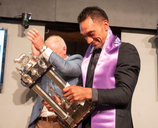 Southland shearer Leon Samuels admires the trophy he won.