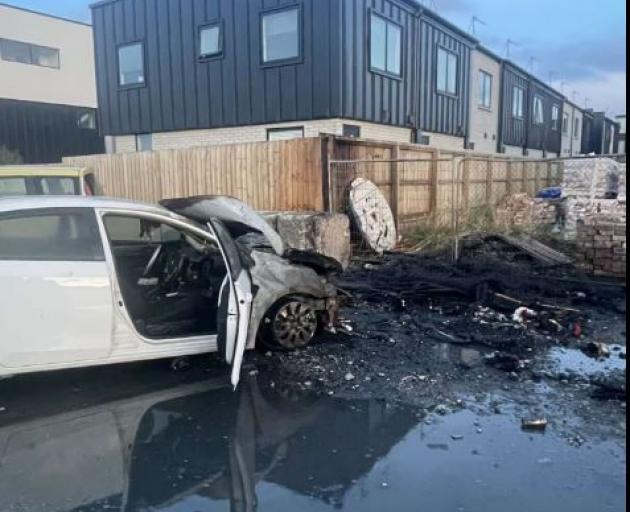 A white vehicle was badly damaged in the blaze. Photo: Connor Nicholson-Plank via NZ Herald