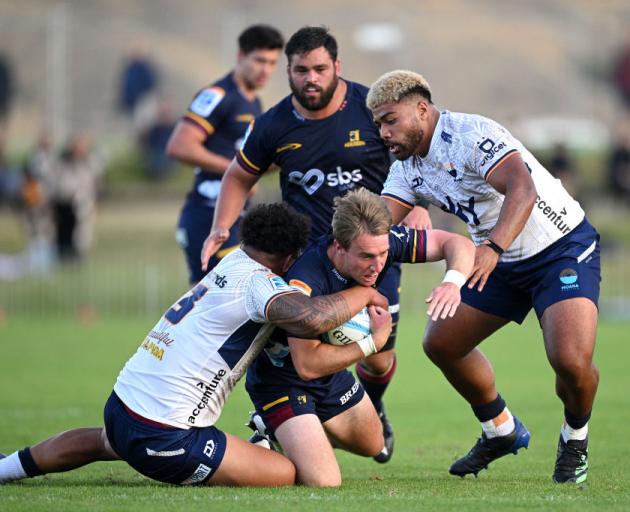 Cameron Millar has Highlanders team-mate Jermaine Ainsley in support as he charges at the Moana...