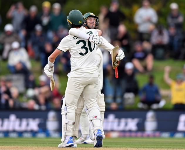 Skipper Pat Cummins and Alex Carey celebrate winning the second test in Christchurch. Photo:...