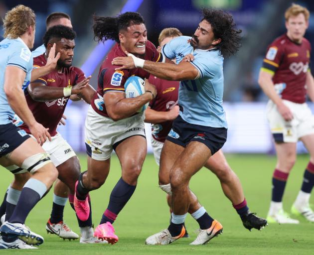 Tanielu Tele’a of the Highlanders is tackled during the round three Super Rugby Pacific match...