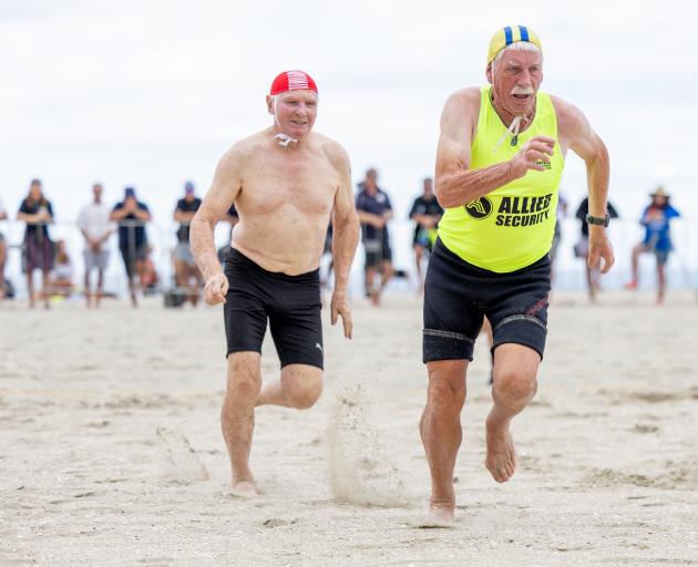 Brighton veteran Dave McPhee (yellow and blue cap) battles Bryan Malyon (Red Beach) in the over...